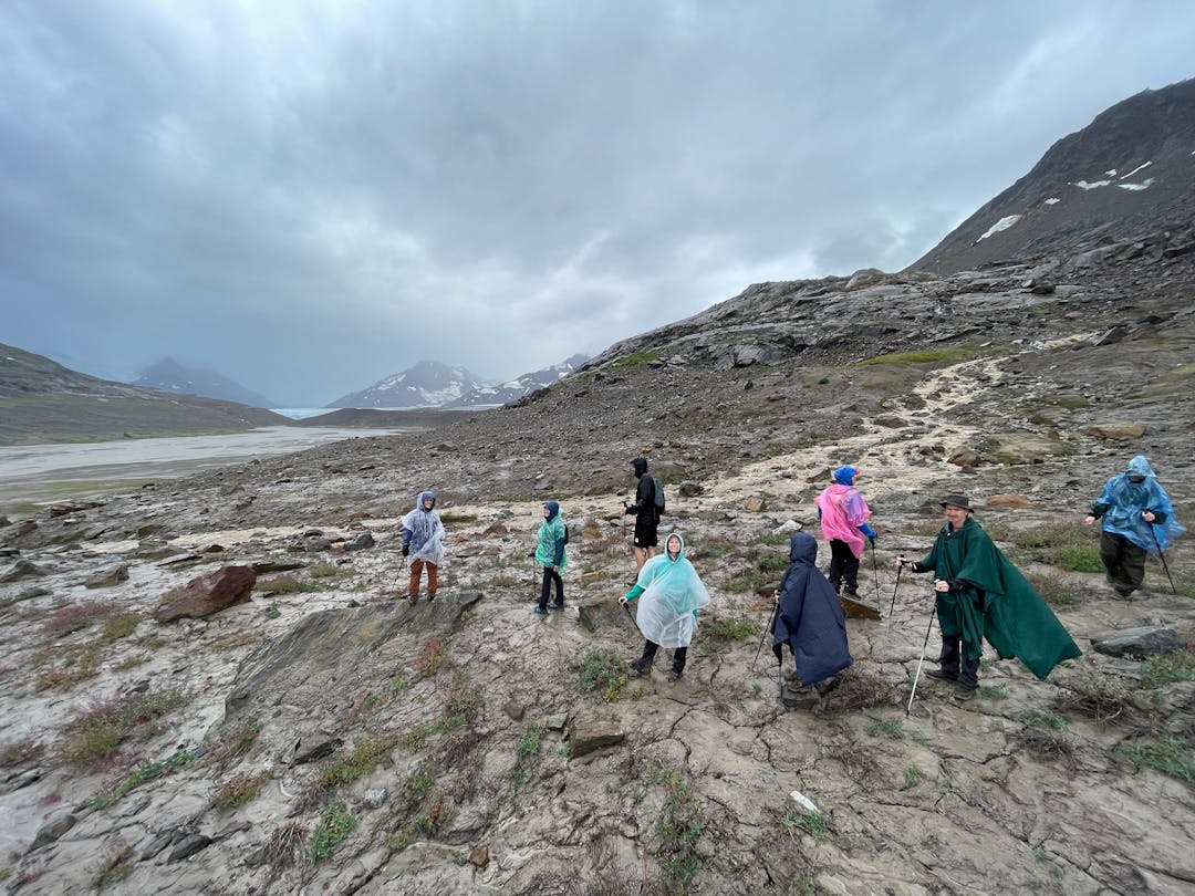 Drenched hikers in ponchos in Alaska