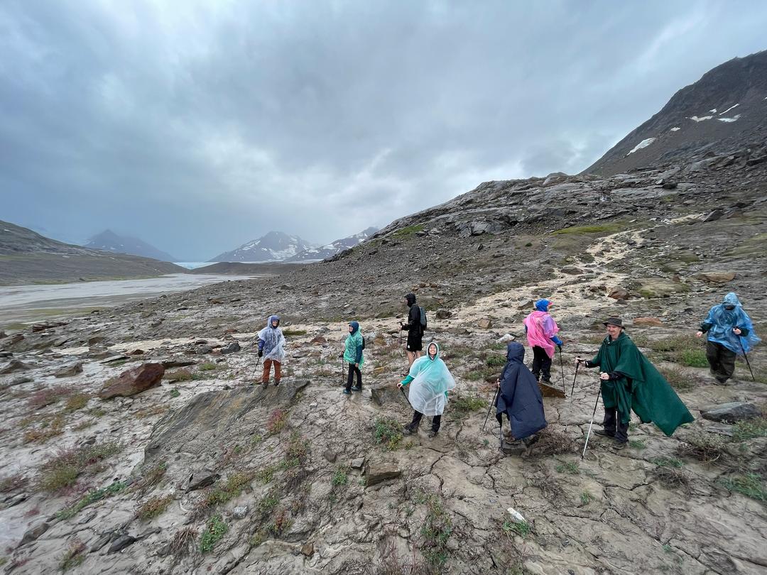Drenched hikers in ponchos in Alaska
