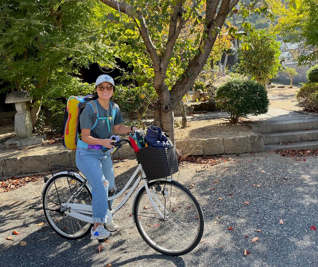Courtney with luggage on a bike