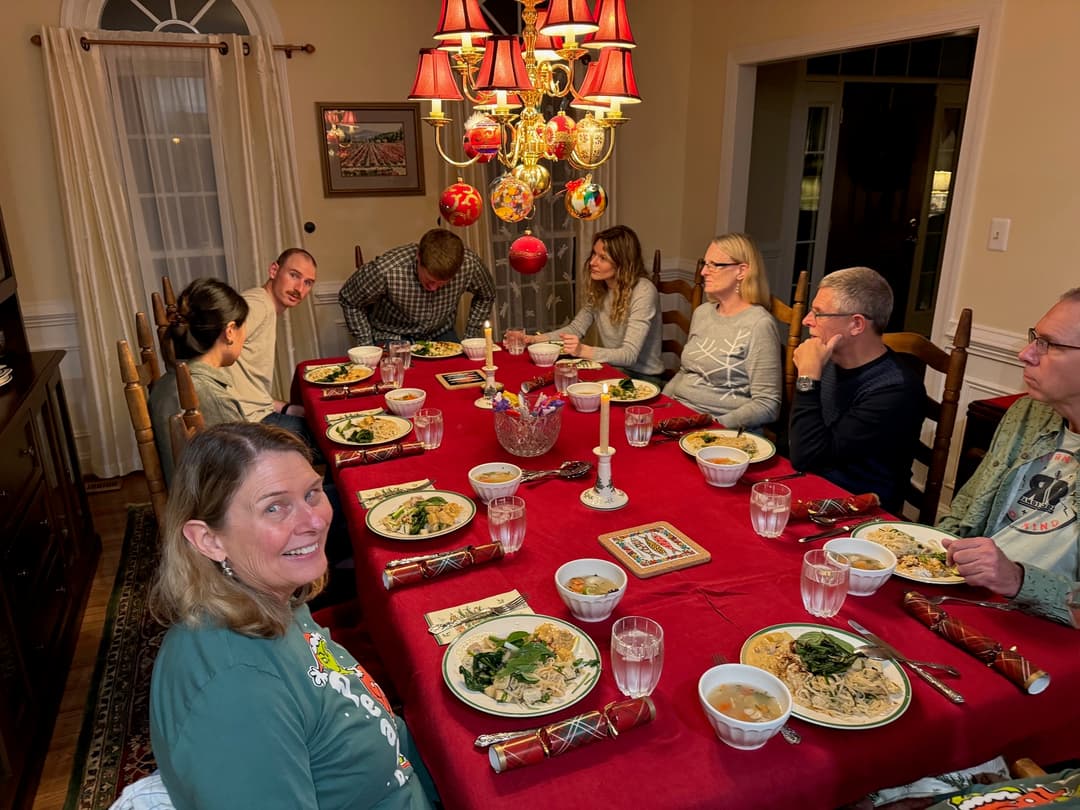 Patrick's family sitting around a table eating Christmas dinner