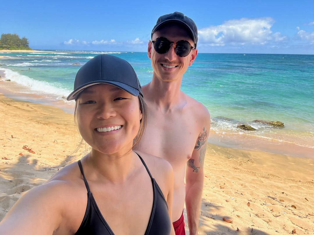 Patrick and Courtney standing on the beach in Hawaii