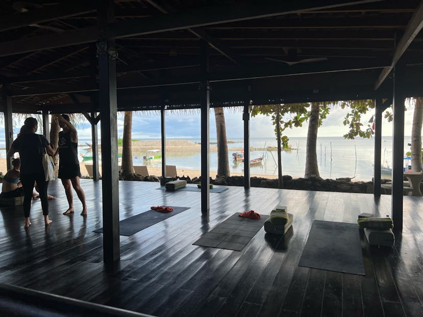 outdoor yoga studio with mats next to the ocean